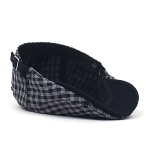 British vintage black and white plaid flat cap with adjustable metal buckle on white background