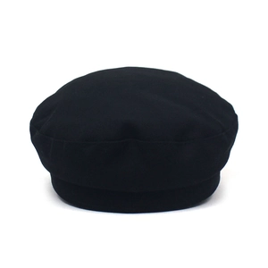 Detailed view of black navy cap featuring a wool fabric texture and flat top design