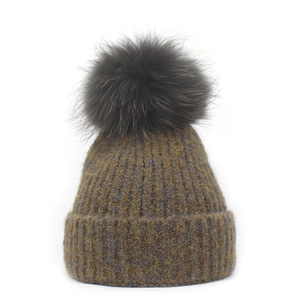 Winter knitted beanie with large fluffy pom pom in olive brown textured knit style