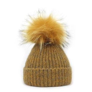 Ginger yellow rib-knitted beanie with a large matching faux fur pom-pom on top