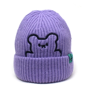 Detail of purple ribbed knit beanie featuring minimalist bear embroidery and small side tag