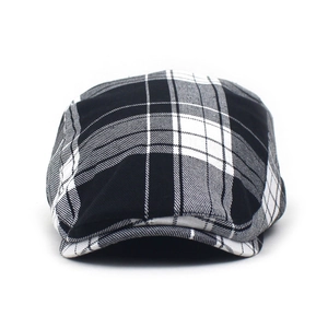 Macro detail of classic black and white plaid flat cap with breathable fabric texture