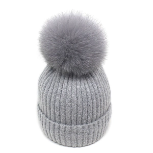 Winter thick cable knit beanie for women featuring a fluffy grey fox fur pom-pom