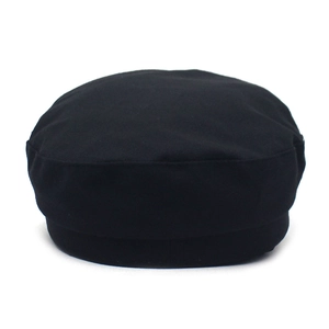 Close-up of black octagonal baker boy hat with cotton texture and minimalist design