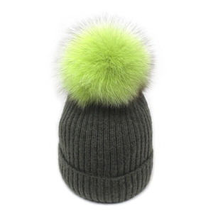 Winter chunky knit beanie in dark grey featuring a large neon green faux fur pompom top