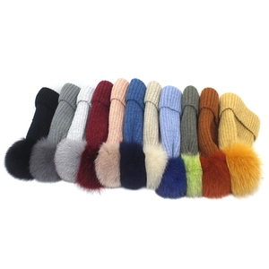 Warm knitted beanie with large faux fur pompom in eleven vibrant colors for winter