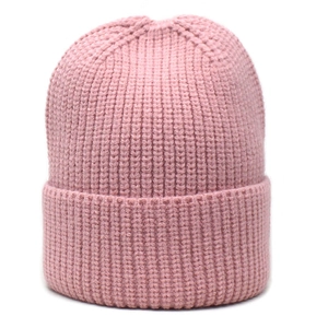 Close-up of pink knitted beanie texture with wide rolled cuff for winter warmth