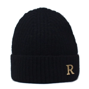 Close-up of black knitted beanie with gold metal R letter on wide folded brim