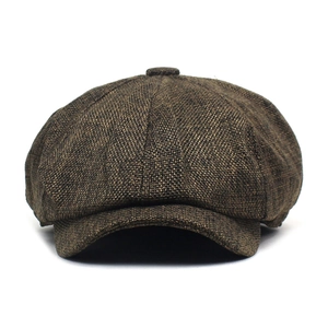 Detailed view of brown newsboy cap with classic eight-piece construction and tweed texture