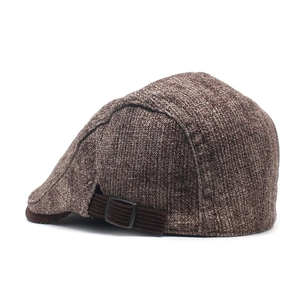 Detail showing the side adjustable buckle and brown corduroy trim on a thick cotton flat cap