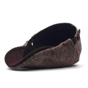 Detail view of winter beret hat with tweed fabric, corduroy brim and metal buckle strap