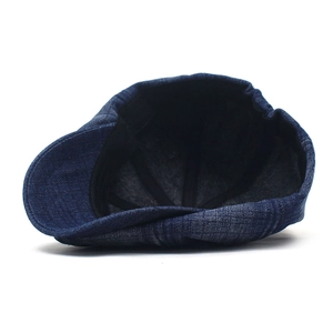 Classic dark blue denim newsboy cap with warm lining and stylish washed cotton texture