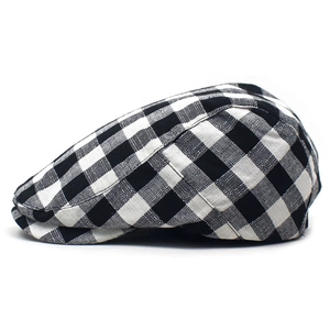 Detailed side profile of a British style black and white plaid ivy cap with premium stitching