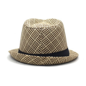 Close-up of geometric twill weave on a straw fedora hat with black fabric decorative ribbon