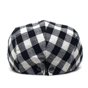Classic British plaid flat cap in black and white checkers with metal rivet back detail