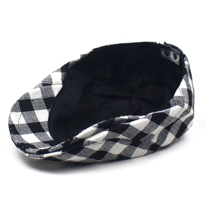 Classic British style black and white gingham flat cap shown from a 45-degree angle