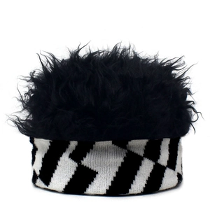 Detail of knit beanie featuring black faux fur top and black-white geometric pattern