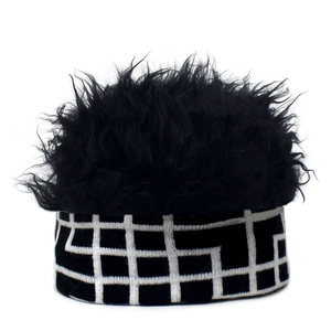 Detail of creative knit wig hat showing black faux fur top and checkered pattern weave