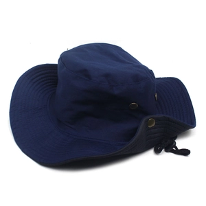 Detail of navy blue sun hat showing stitching on wide brim and bronze side buttons