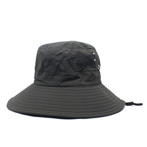 Detail view of dark grey bucket hat with metal eyelets and adjustable windproof cord