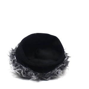 Close-up of a black winter knit beanie hat featuring grey faux fur trim on white background