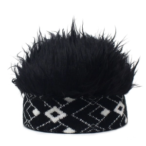 Detail of creative knit beanie featuring black faux fur top and diamond pattern cuff