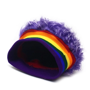Detail of vibrant rainbow stripe knit trim on a fluffy purple long-pile wig beanie hat