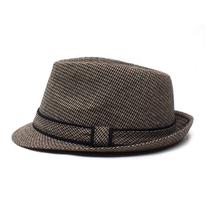Detail of classic brown and black houndstooth pattern fabric on a structured jazz hat