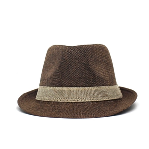 Detailed view of dark brown woven fedora hat texture with beige striped hatband