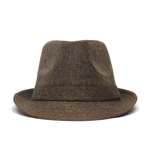Detailed close-up of dark brown woven fedora hat with a classic vintage indented crown