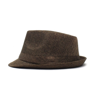 Detailed texture of dark brown linen fedora hat with matching decorative ribbon band