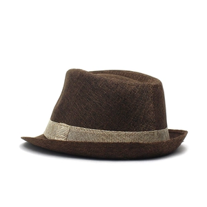 Detailed view of dark brown linen fedora hat featuring breathable woven texture and band