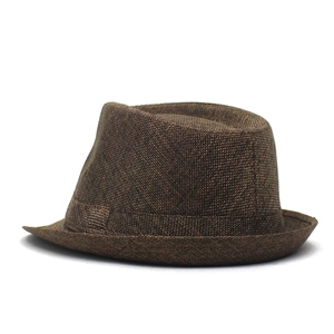 Detail of dark brown linen texture and woven band on a classic vintage trilby jazz hat