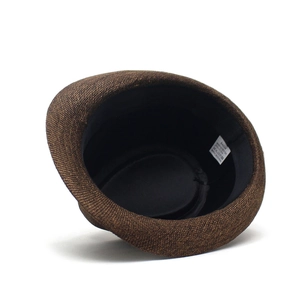 Detailed close-up of dark brown woven fedora showing inner sweatband and size label