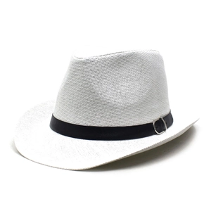 Close-up detail of white woven straw hat texture with black band and silver metal buckle
