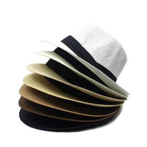 Détail de chapeaux de paille en papier multicolores avec rubans décoratifs noirs