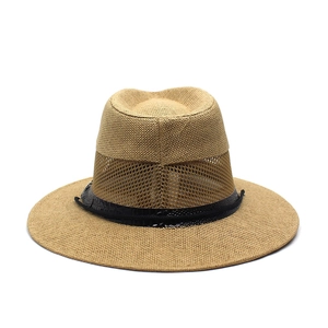 Close-up of khaki straw hat featuring breathable mesh crown and crocodile texture band