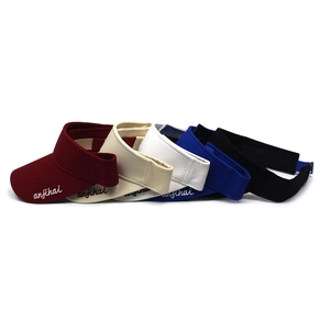 Stack of colorful sun visors with letter embroidery showing adjustable velcro straps