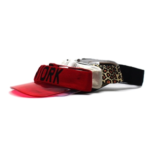 Detail view of colorful open top sun visors with PVC brims in red and leopard patterns