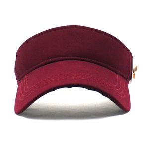 Close-up of a burgundy sun visor hat with detailed reinforced stitching on the brim