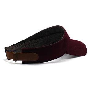 Detail of burgundy velvet sun visor with adjustable leather strap and metal buckle