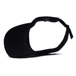 Detail view of the black cotton visor showing the internal brand label and adjustable strap