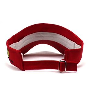 Detail of red sun visor hat showing adjustable hook-and-loop strap and metal buckle