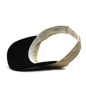 Detail view of cotton sun visor with internal sweatband and 100 percent cotton label