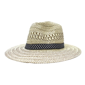 Classic wide-brim straw sun hat in light brown with a black and white striped ribbon band