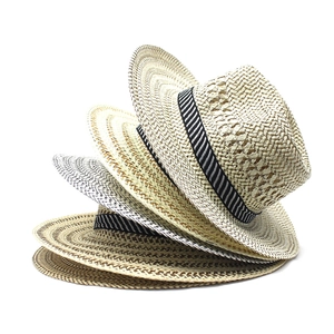 Detailed close-up of stacked straw hats showing woven texture and decorative ribbons