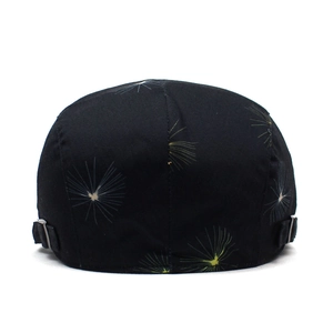 Detail view of cotton beret back showing dandelion print and metal side buckles