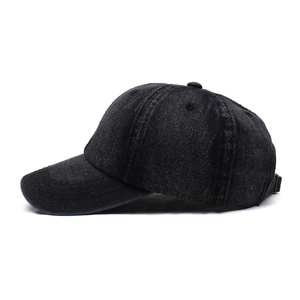 Detail of vintage washed black denim baseball cap with adjustable bronze metal buckle