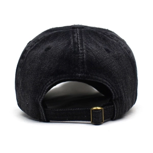 Detail of adjustable metal buckle and strap on black washed denim baseball cap