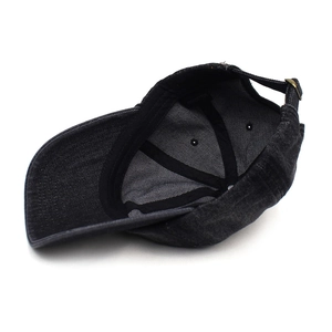 Detail view of cotton baseball cap interior showing stitching and metal buckle strap